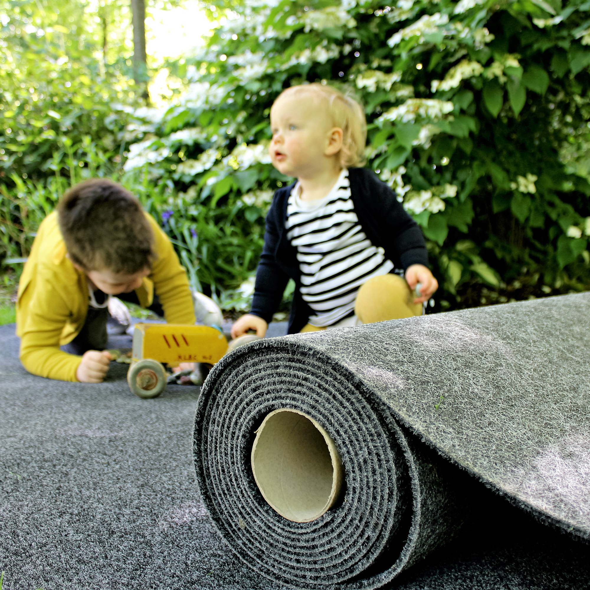 Kids on a roll of carpet